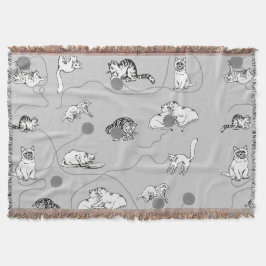 Niedliche Katzen spielen und ein schwaches Muster Decke
