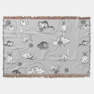 Niedliche Katzen spielen und ein schwaches Muster  Decke