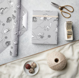 Niedliche Katzen spielen und ein schwaches Muster Geschenkpapier