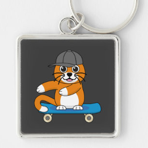Niedliche orangefarbene Katze auf Skateboard Carto Schlüsselanhänger