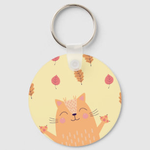 Niedliche orangefarbene Katze spielt im Herbstlaub Schlüsselanhänger