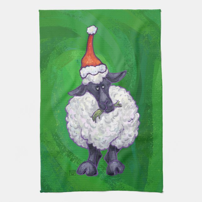 Niedliche Schafe in Weihnachtsmannmütze auf grün Küchentuch (Vertikal)