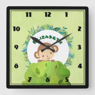Niedlicher Affe, der sich von Hinter Bush heraushä Quadratische Wanduhr