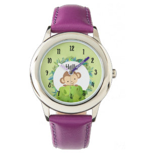 Niedlicher Affe, der von hinter Bush herbeiwindet Armbanduhr