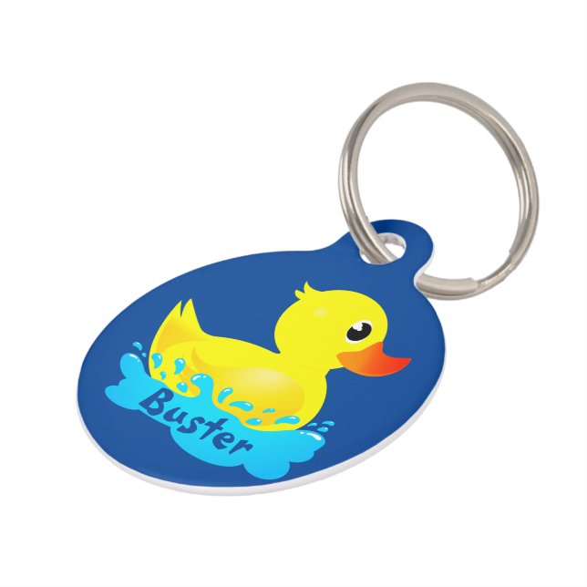 Niedlicher Gelber Gummi-Ente, der sich um Haustiermarke (Seite)