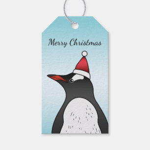 Niedlicher Gentoo Pinguin mit einer Weihnachtsmann Geschenkanhänger