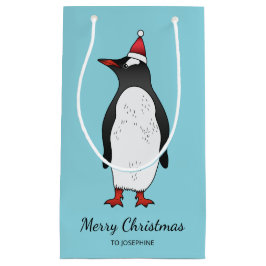 Niedlicher Gentoo Pinguin mit einer Weihnachtsmann Kleine Geschenktüte