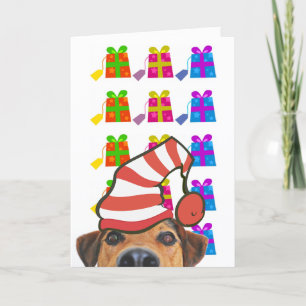 Niedlicher Hund mit Weihnachtsmannmütze und Gesche Feiertagskarte