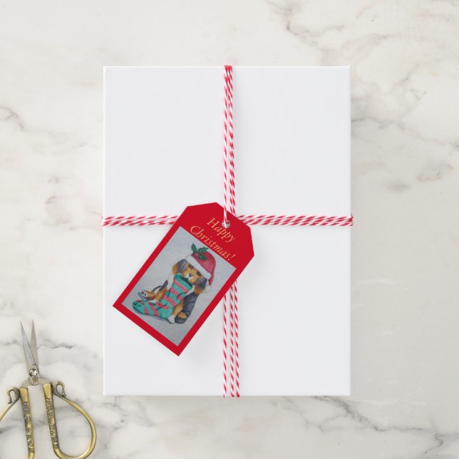 niedlicher, schwarz-brauner Welpe mit Weihnachtswe Geschenkanhänger (Mit Garn)