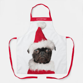 Niedlicher Schwarzer Mops in der Weihnachtsmannmüt Schürze