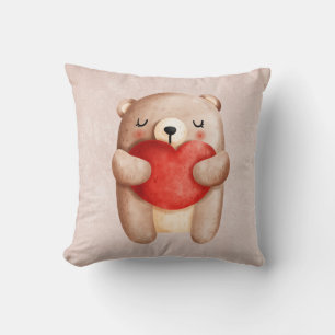 Niedlicher Teddybär mit einem roten Herz Kissen