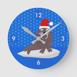 Niedlicher Weihnachtswalrus und Schneeflocken Runde Wanduhr