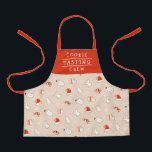 Niedliches Keks Crew Weihnachtsmuster Schürze<br><div class="desc">Die Schürze bietet ein fröhliches Weihnachtsgebäck - eine Weihnachtsmannmütze, Schneemann, Weihnachtsbaum, einen Engel, Fäuste und einen Bonbons. Der Text lautet "COOKIE TASTING CREW", aber er kann angepasst werden, um alles zu sagen, was man möchte. :) Das Rot ist eine orange - rote Farbe, der Hintergrund ist beige. Eine tolle Geschenkidee...</div>