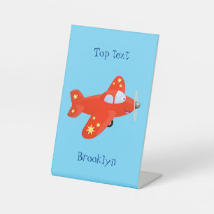 Niedliches rotes Flugzeug mit Cartoon Sockelschild
