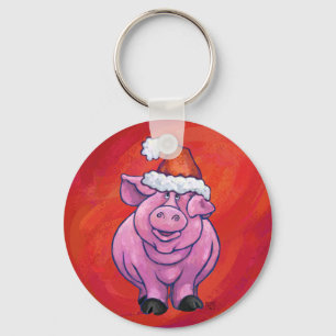 Niedliches Schwein in Weihnachtsmannmütze auf Rot Schlüsselanhänger