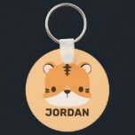 Niedliches Tiger mit Personalisiertem Namen Schlüsselanhänger<br><div class="desc">Ein niedliches Design,  das Ihren Tag aufhellt. Dieses Design bietet eine niedliche Tiger Cartoon-Abbildung mit personalisiertem Namen in braun modernen Sans Serif Schriftart Stil auf pastellorange Hintergrund. Perfekte personalisierte Geschenke für Kinder.</div>