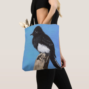 Oiseau de Phoebe noir sur le sac fourre-tout bleu