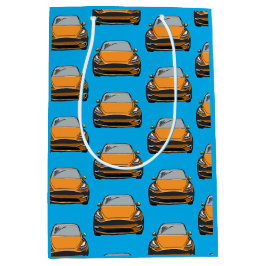 Orange Electric Vehicle SUV Car Blue Background Mittlere Geschenktüte