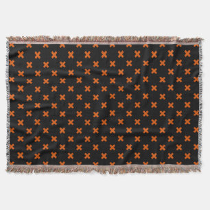 Orangefarbene Kreuzstiche auf schwarz Decke