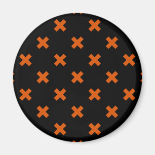 Orangefarbene Kreuzstiche auf schwarz Magnet