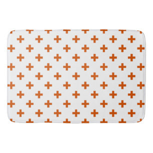 Orangefarbene Polka-Kreuze auf weiß Badematte