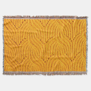 Orangefarbener Pullover, texturierter Hintergrund. Decke