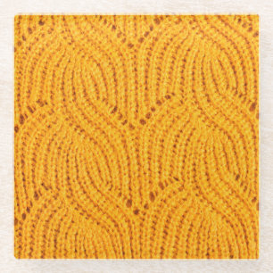 Orangefarbener Pullover, texturierter Hintergrund. Glasuntersetzer