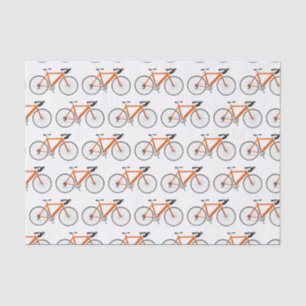 Orangefarbenes Fahrrad auf weißem Gewebe Seidenpapier
