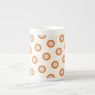 Orangefarbenes Kreiseldrehpunktdesign Prozellantasse