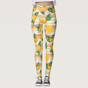 Orangefarbenes Muster mit grünen Blätter auf Paste Leggings