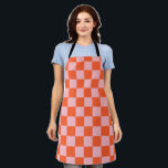 Orangefarbenes und rosafarbenes Prüfmuster Schürze<br><div class="desc">Orangefarbenes und rosafarbenes Karton-Muster in Rosa und Orange.</div>