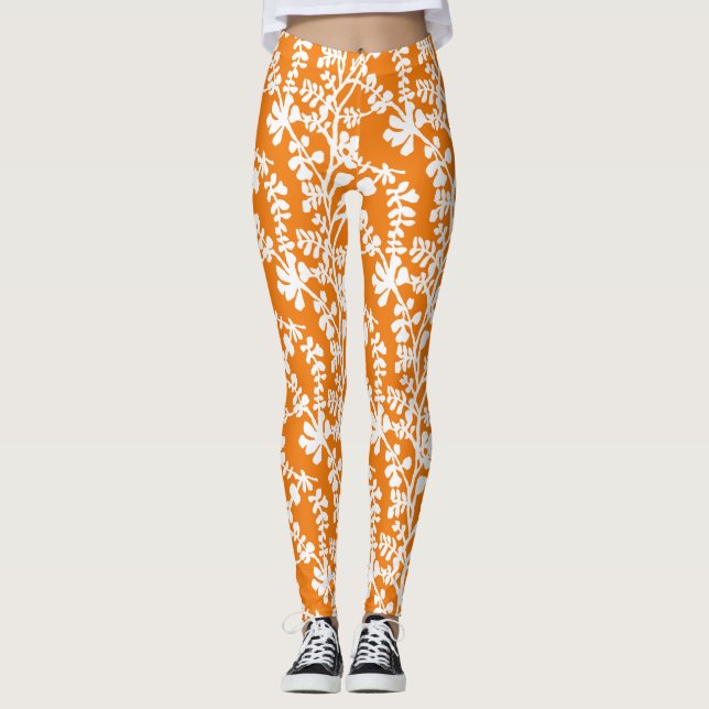 Orangefarbenes und weißes, florales Wiederholmuste Leggings (Vorderseite)