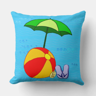 Oreiller jeté parapluie et balle sur les vagues