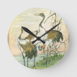 Orientalische Kräne durch das Wasser Runde Wanduhr