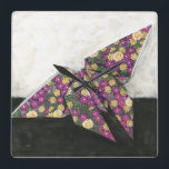 Origami Schmetterling auf Blumenpapier Quadratische Wanduhr<br><div class="desc">Schwimmen Sie wie ein Schmetterling mit diesem schönen origami Stück durch Chariklia Zarris. Ein reizendes Blumendruckpapier wurde benutzt, um den origami Schmetterling herzustellen, und die Purpur, die Gelbs und die Grüntöne springen einfach weg vom Stück. Kaufen Sie Ihre Kopie heute!</div>