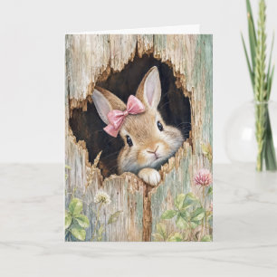 Osterhase mit rosa Schleife in Zaunloch Karte