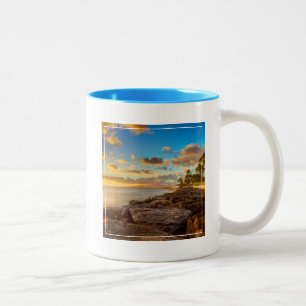 Ozean-Sonnenuntergang über Felsen und Palme   Zweifarbige Tasse