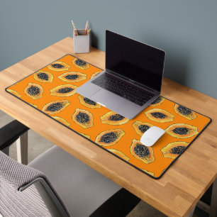 Papaya-Scheiben auf Orange Schreibtischunterlage