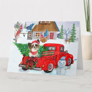 Papillon-Hund im Weihnachtslieferwagen Schnee Karte