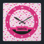 Pastel Hearts on Pink Personalized Quadratische Wanduhr<br><div class="desc">This cute girly clock features a light pink,  purple,  orange & green heart pattern background accented with a pink stripe and a pink box with customizable text for personalization.  This pink heart clock makes a perfect accent for a girls bedroom.</div>