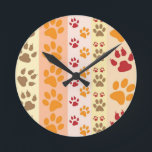 Paw Prints cute Dog Lovers Runde Wanduhr<br><div class="desc">Design with a cute pattern of dog paw prints in orange and yellow and warm colours. This design looks as though a dog has walked over the product ! For dog lovers everywhere.</div>
