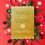 Peace Joy Liebe Typografie Snowflake Gold Glitzer Feiertagskarte<br><div class="desc">"Frieden, Freude und Liebe." Eine lustige, spielerische, weiße Schneeflocke-Illustration und eine moderne Typografie auf funkelnd, Imitat Gold Glitzer Hintergrund helfen Ihnen, in der Ferienzeit. Weiße Schneeflocken und Konfetti-Punkte umrahmen die Karte. Ein weißes Schneeflockenmuster überlagert dunkelgrün auf der Rückseite. Fühlen Sie die Wärme und Freude der Ferien, wenn Sie diese atemberaubende,...</div>