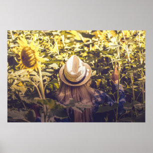 Person mit weißem Hut neben Sonnenblumenfeldern Poster