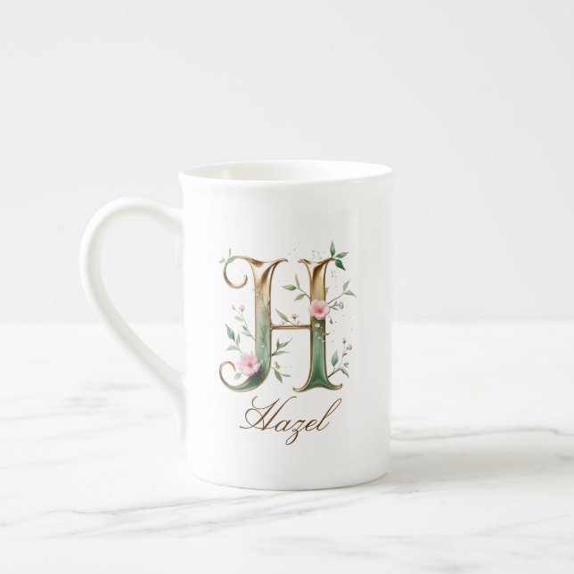 Personalisierter goldener Blumenmonogramm-Initiale Prozellantasse (Links)