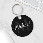 Personalized Black Monogram and Name Schlüsselanhänger<br><div class="desc">Personalized Monogram and Name Gift
features personalized name in white script font style and monogram in grey serif font style as background,  on black background.

Perfect as holiday gift,  family reunion favors,  thank you gift for groomsmen and gift for any special occasions.</div>