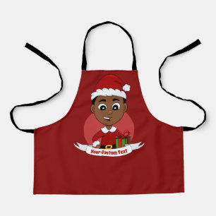 Petit garçon de Noël avec tablier casquette rouge