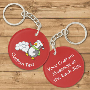 Pingouin de Noël avec boules de neige brandissant 