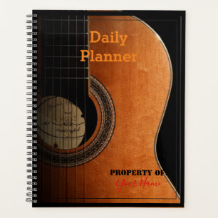 Planificateur quotidien avec une guitare sur la co