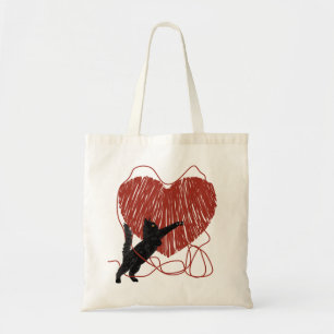 Playful Black Cat Unraveling Red Heart Tragetasche