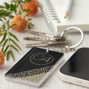 Plumes d'or sur le monogramme de Glitterie Noire